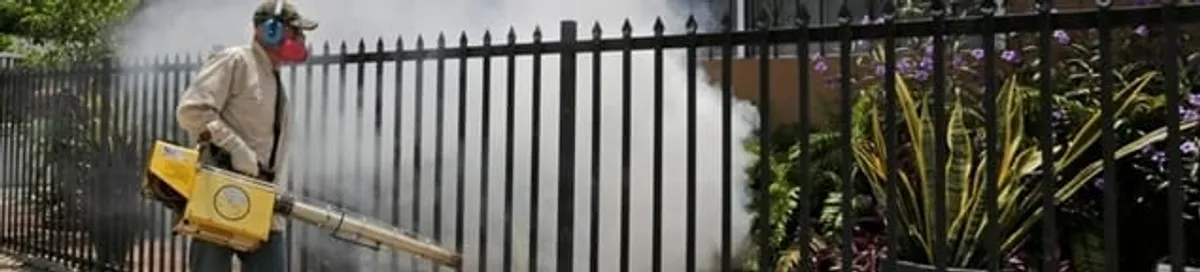 Mosquito control technician fogging a yard perimeter for mosquito reduction in Cape Coral, FL